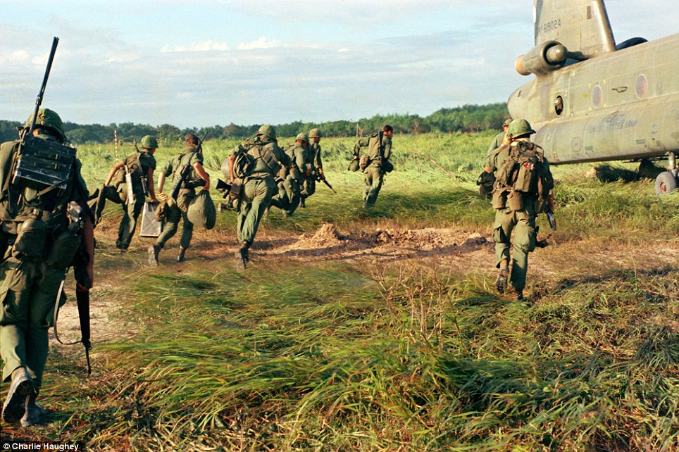 Evocative: This photograph showing American soldiers boarding a Chinook helicopter is one of 2,000 taken by Charlie Haughtrey during his tour of duty