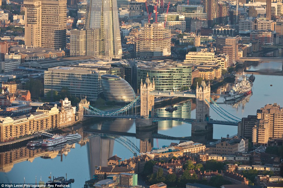 The pond-like surface of the River Thames shows barely a ripple of life in the extraordinary photographs