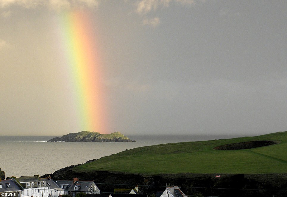 Goldie looking rain: Emily Walton's picture of the rainbow that suddenly light up the murky island in Trevorne Bay in Padstow, Cornwall
